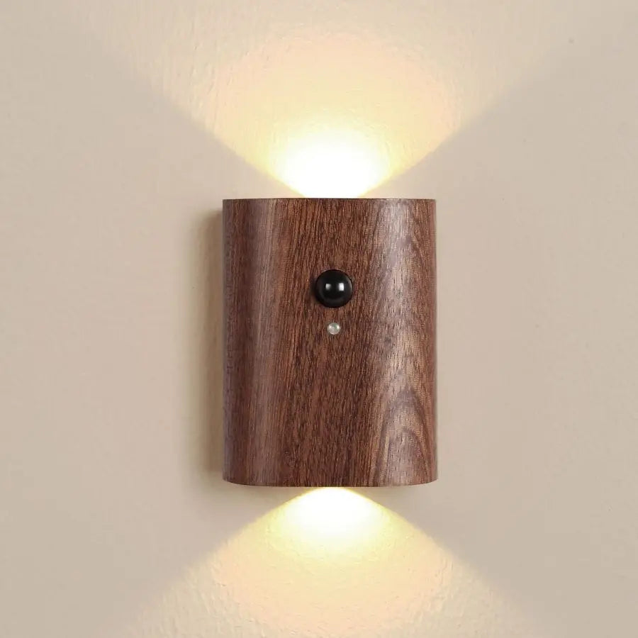 Dark wood sensor wall light lit on a plain cream wall