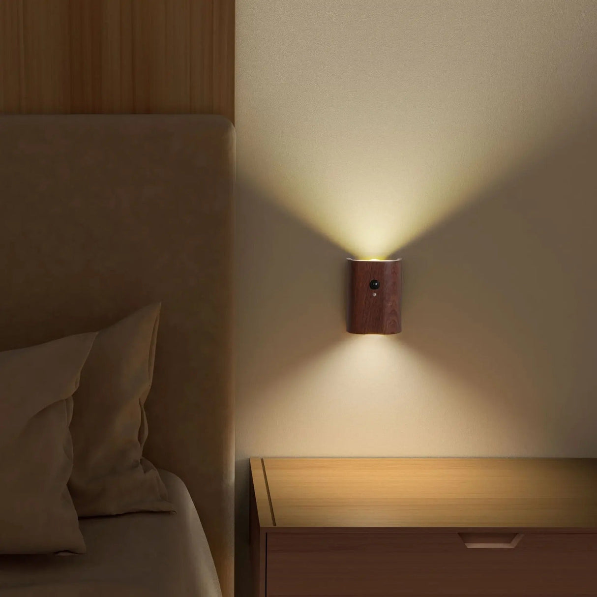 Dark wood sensor light lit on a wall beside a bed and lamp