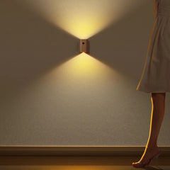 Wood sensor wall light lit as a person walks past a plain wall
