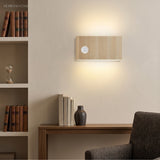 Wood wall-mounted sensor light in a study nook with bookshelf