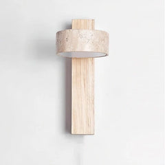 Alternate view of the natural wood travertine wall sconce against a wall