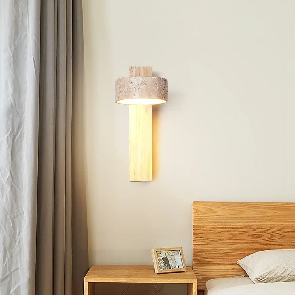 Natural wood travertine wall sconce beside a curtain above a bedside table