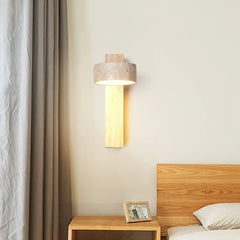 Natural wood travertine wall sconce beside a curtain above a bedside table