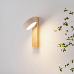 Close view of the natural wood sconce with its travertine shade rotated