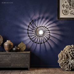 Nautilus shell wall light on a purple wall with decor