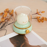 Night light photographed from above with dried flowers and a paper print