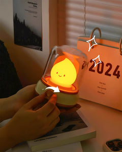 Hand adjusting the knob of the night light on a desk in front of a calendar