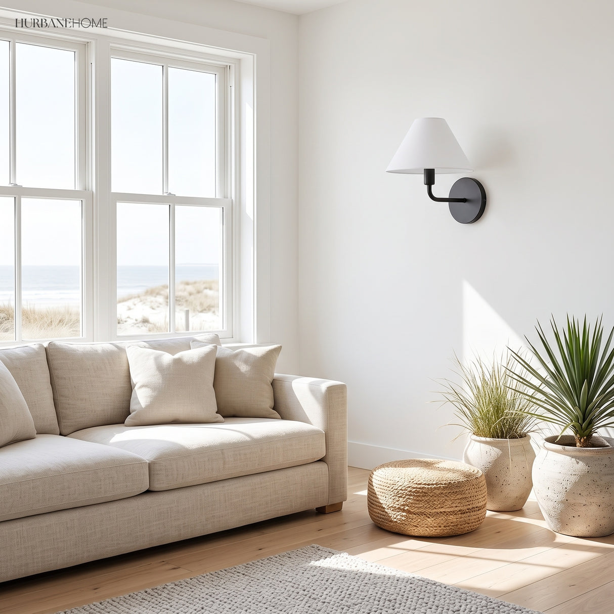 Black cone wall sconce in a bright coastal living room by a window