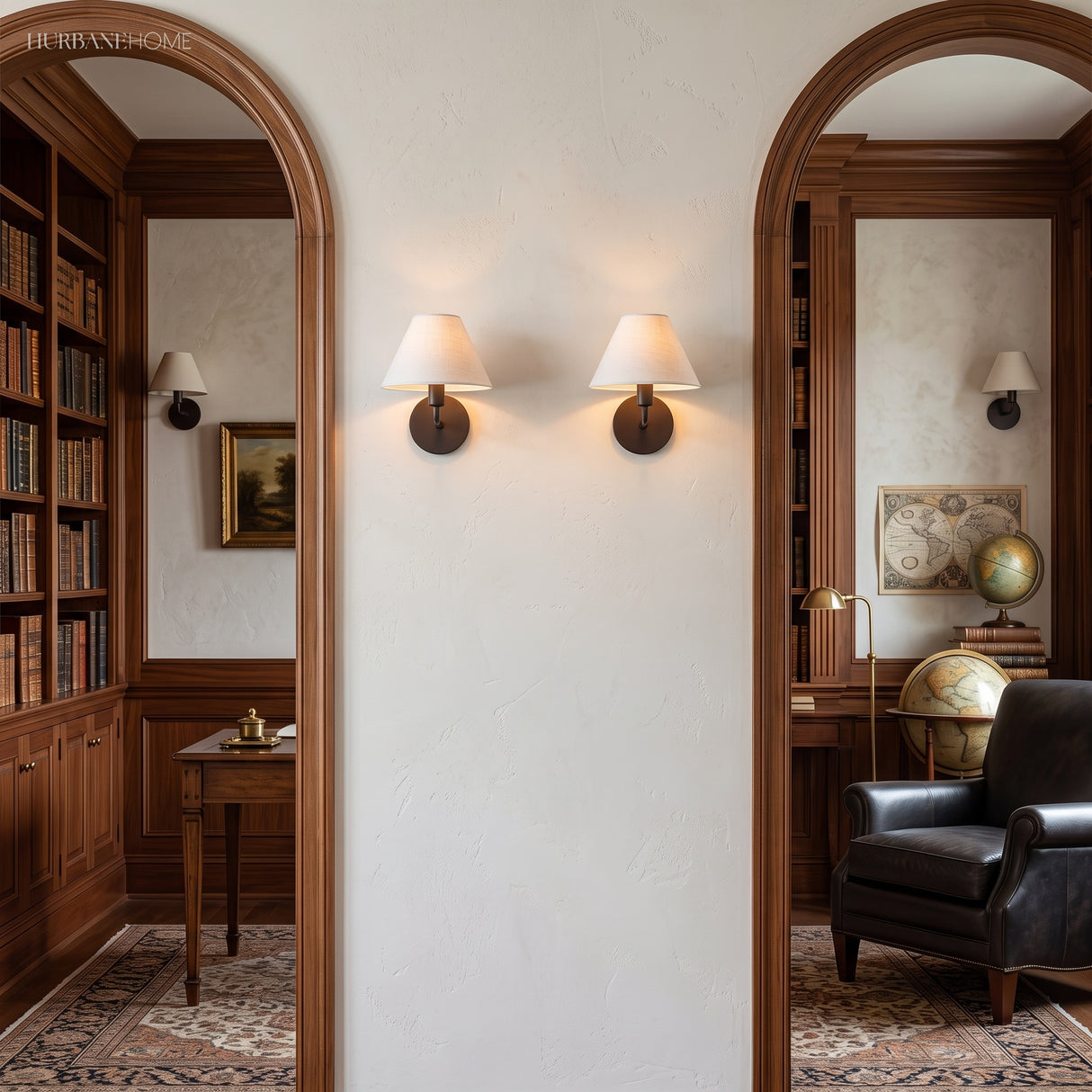 Two fabric cone sconces between arched openings in a panelled library