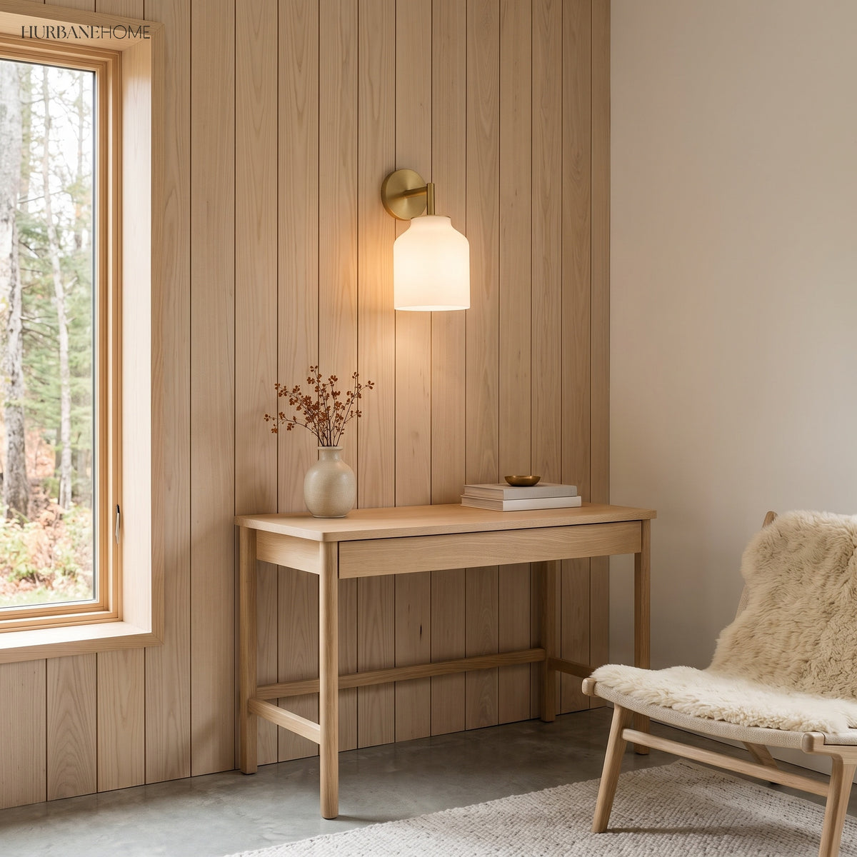 Nordic wall sconce on timber panelling above a slim writing desk