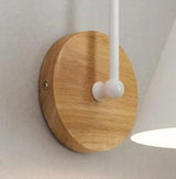 Close view of the round wood backplate and the curved arm
