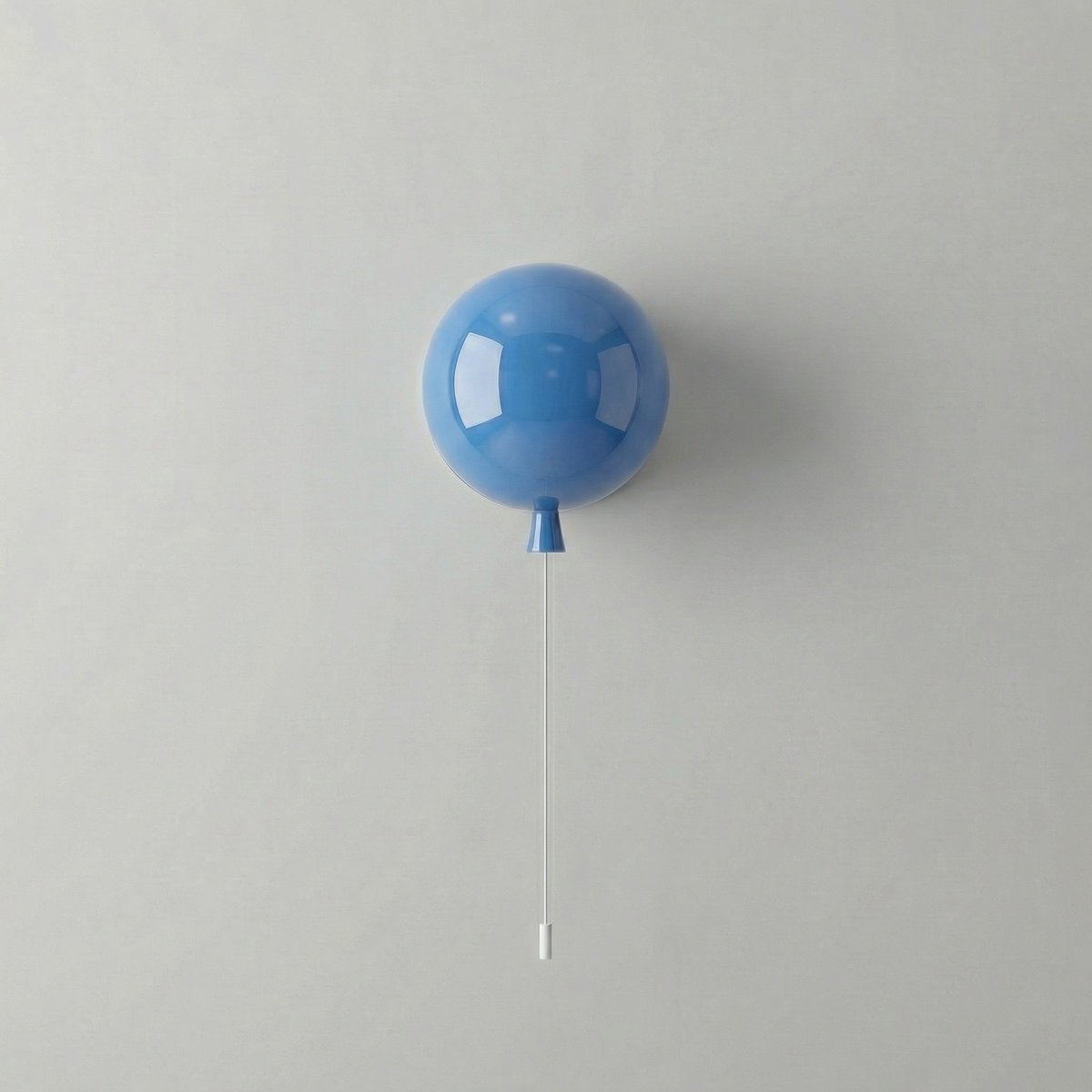 Blue balloon light mounted on a white wall with a hanging cord