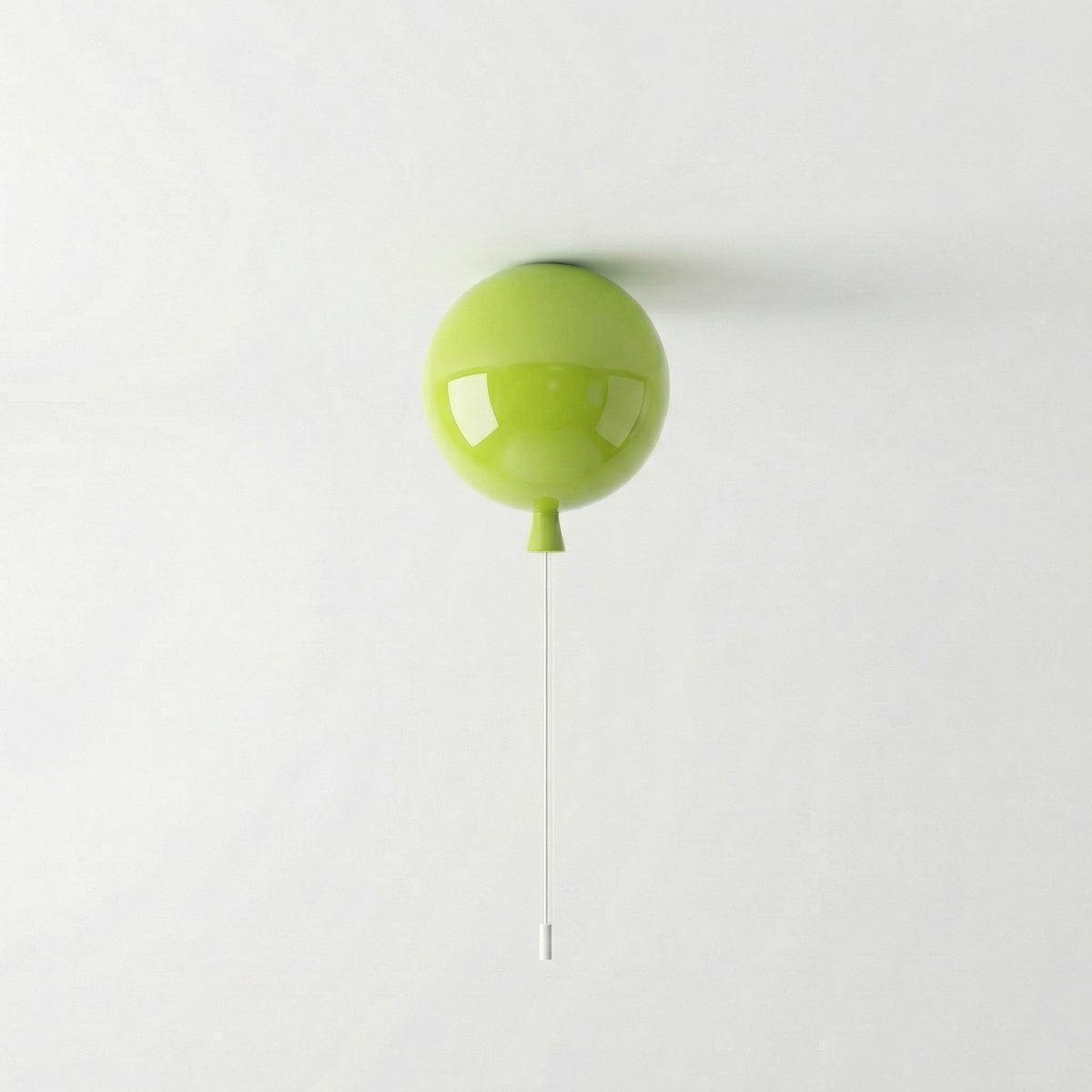 Lime green balloon light fitted to a ceiling with a pull cord