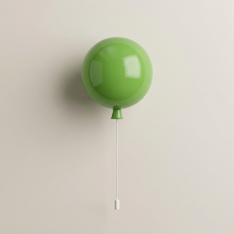 Large green balloon light mounted on a warm beige wall
