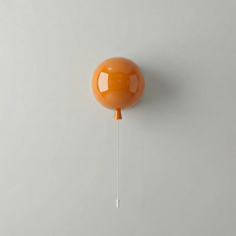 Orange balloon light mounted on a white wall with a pull cord
