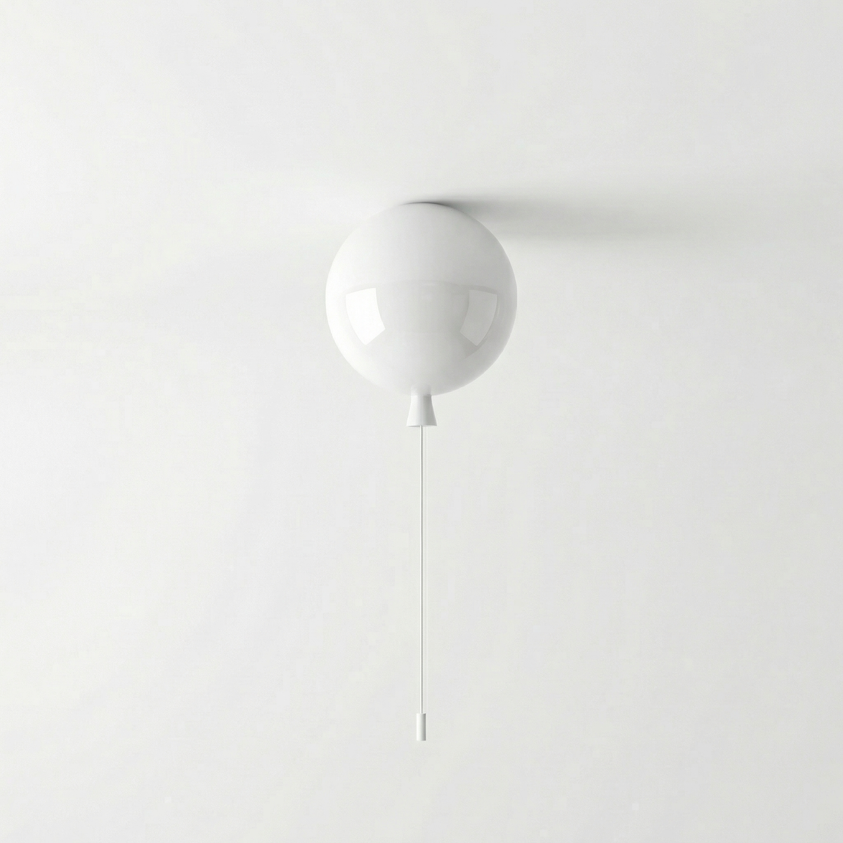 White balloon light fitted to a ceiling above a plain grey wall