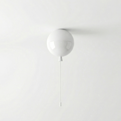 White balloon light fitted to a ceiling above a plain grey wall