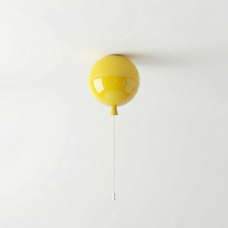 Yellow balloon light mounted on a ceiling with its cord hanging