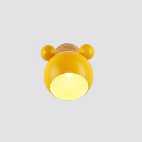 Yellow mouse wall light on a wood mount seen from the front