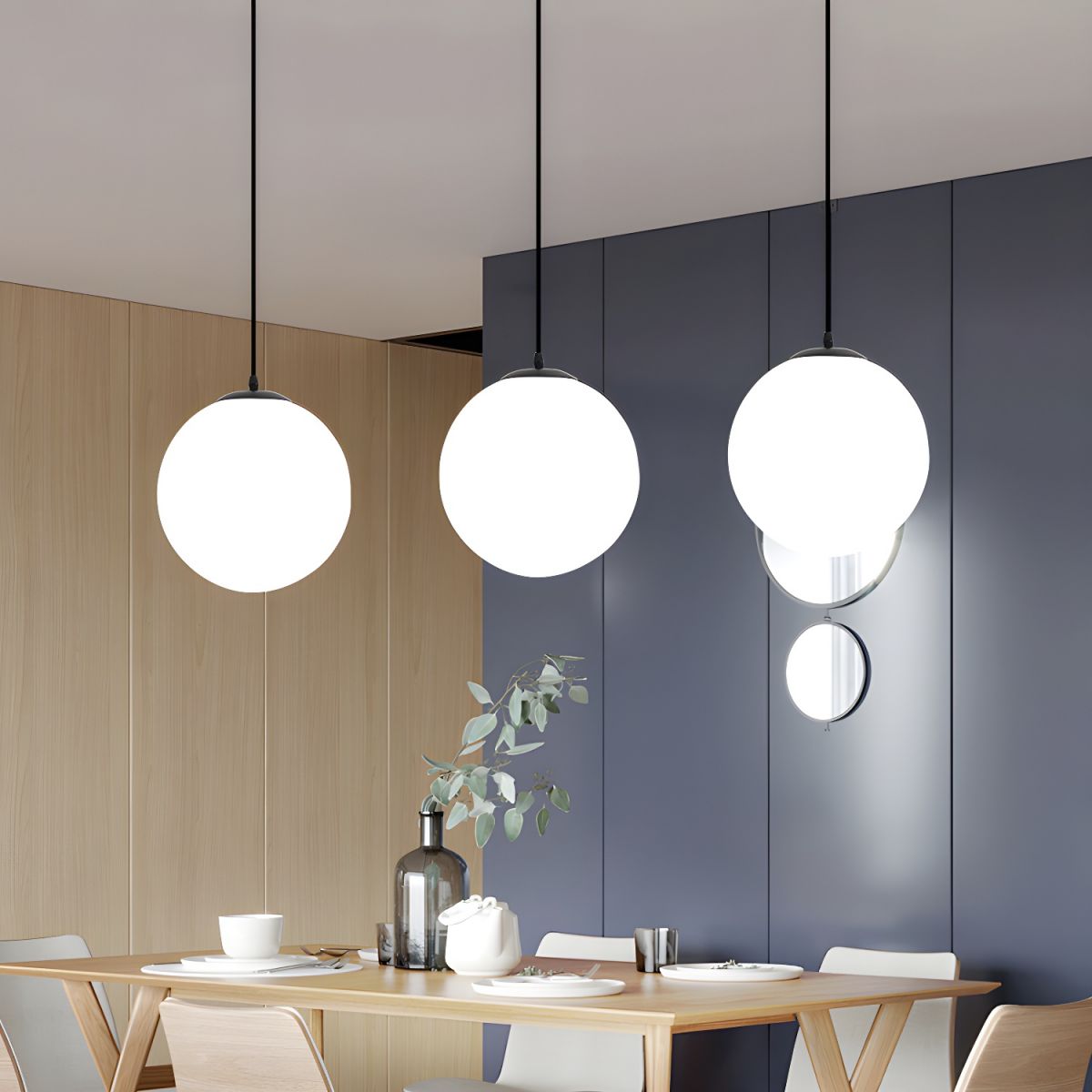Three opal glass globe pendants above a light timber dining table