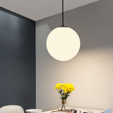 Row of opal glass globe pendants above restaurant booth seating