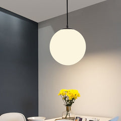 Row of opal glass globe pendants above restaurant booth seating