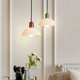 Orange glass dome pendant light shown against a neutral studio backdrop