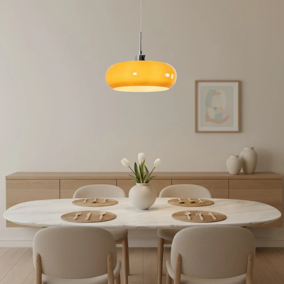 Single orange glass pendant light above an oval marble dining table