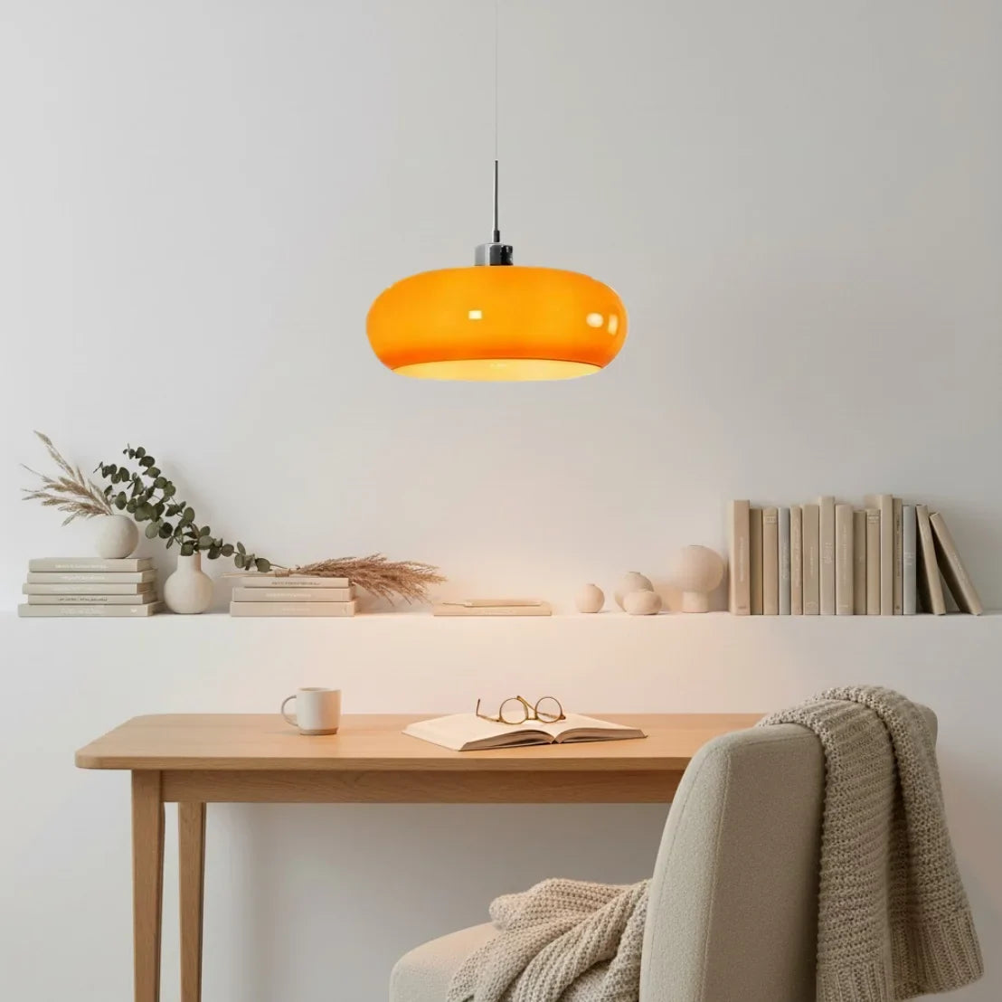 Orange and white glass pendant lights stacked above a bedroom nightstand
