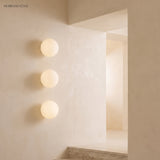 Frosted glass orb wall sconces in a styled interior