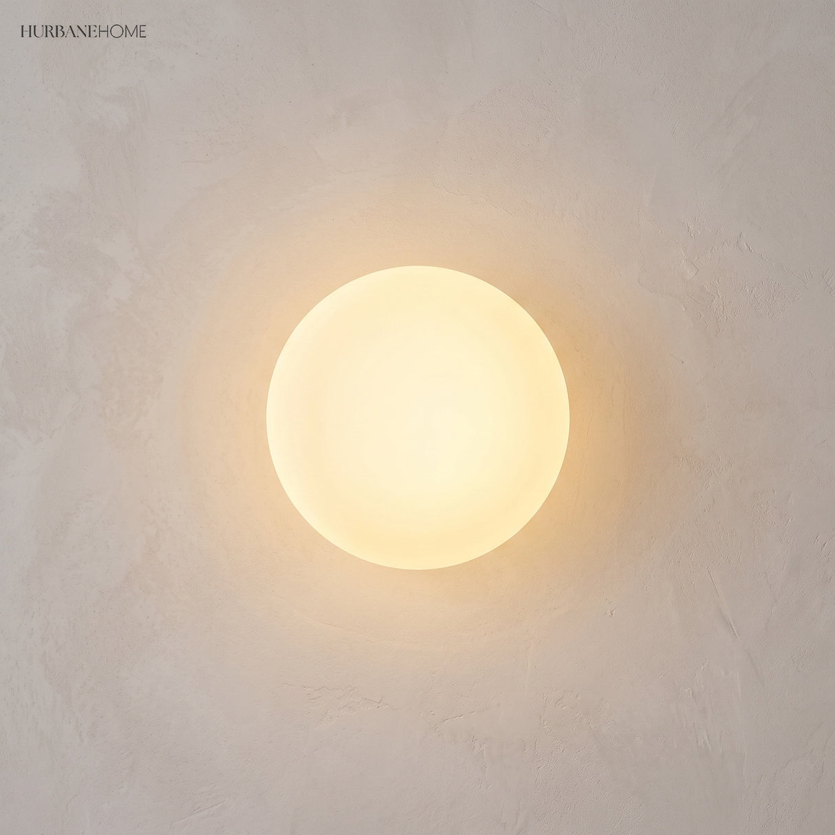 Frosted glass orb wall sconce in a styled interior