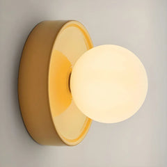 Orb wall sconce lit up showing the warm glow through the frosted globe