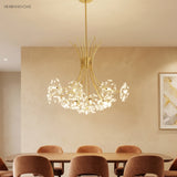 Gold crystal dandelion chandelier over a warm neutral dining setting