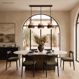 Three-head travertine pendant light over a round dining table