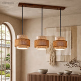 Travertine pendant light with woven rattan band over a kitchen island