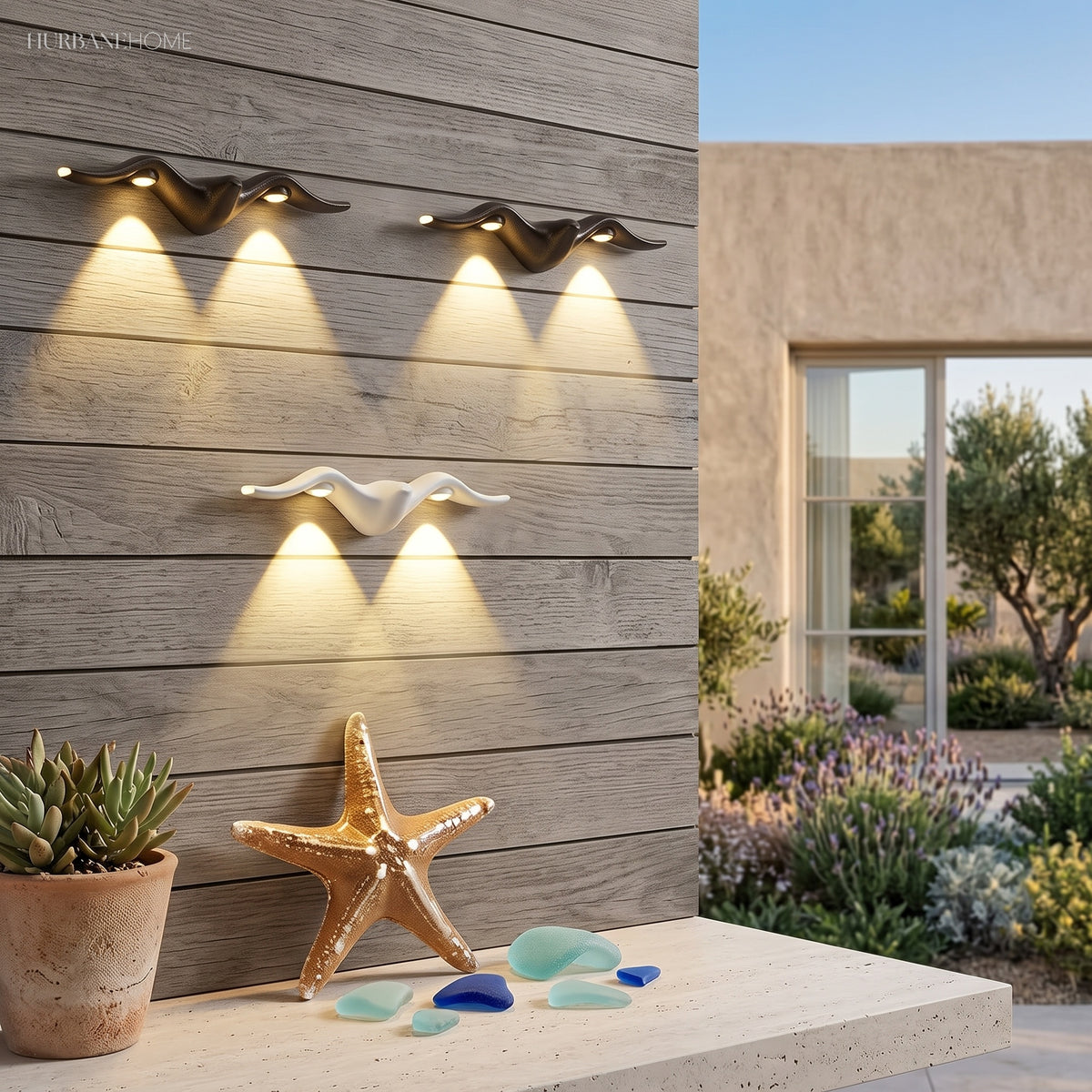 Two starfish lights casting rays across a pale courtyard wall