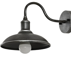 Antique silver barn light seen from the side on a white ground