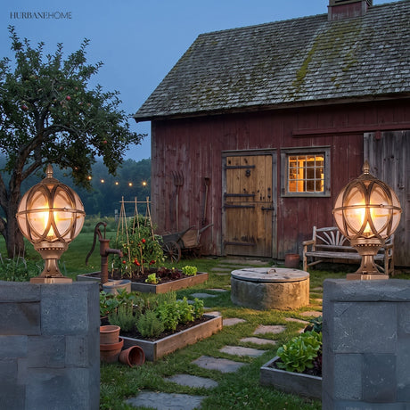 Two caged post lanterns marking a rustic farm gate at sunset