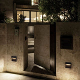 Two step lights lighting a stone entrance and a vented wall panel