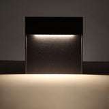 Close view of warm light spilling from the step light onto a wall