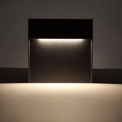 Close view of warm light spilling from the step light onto a wall