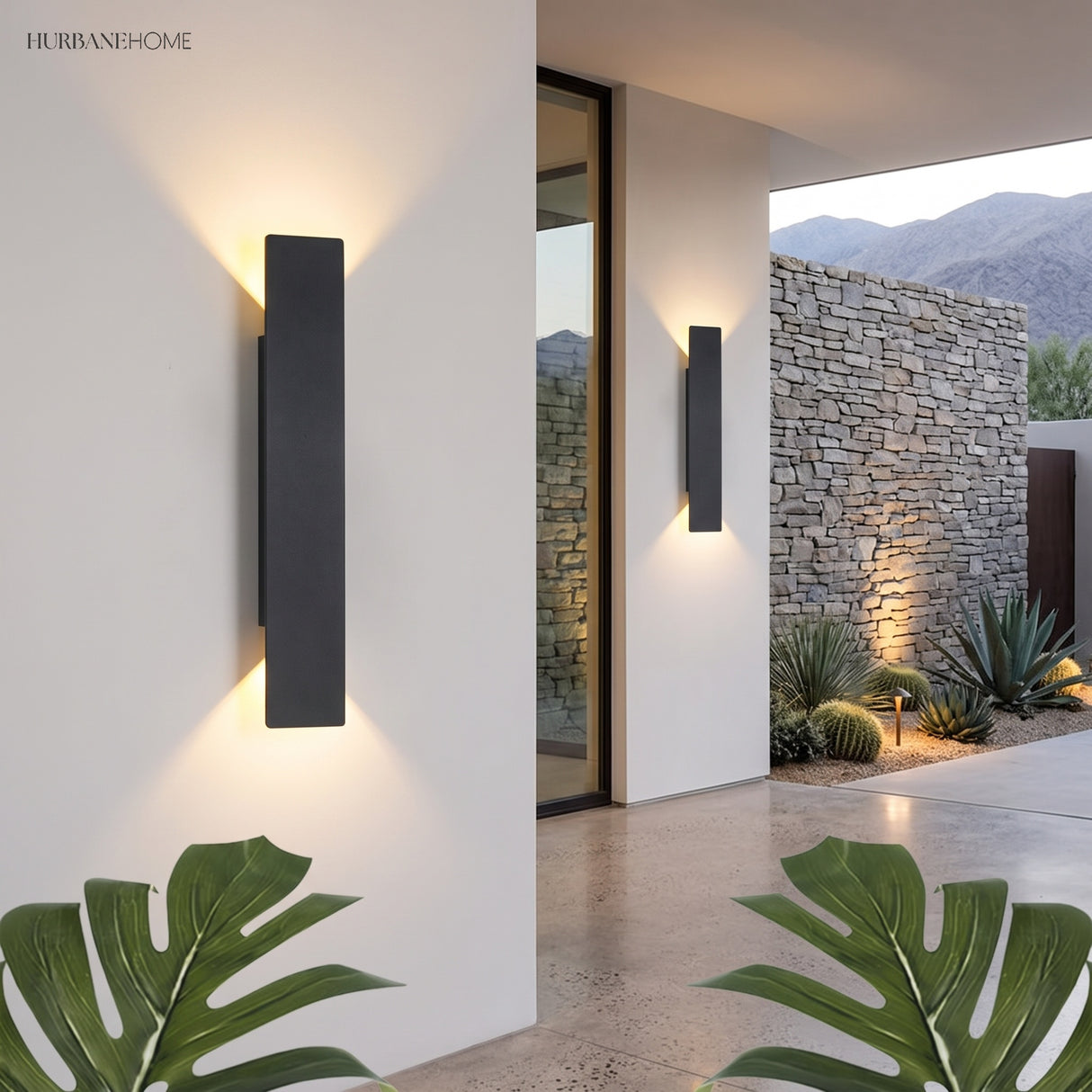 Two black LED outdoor wall lights casting up and down glow on entryway wall