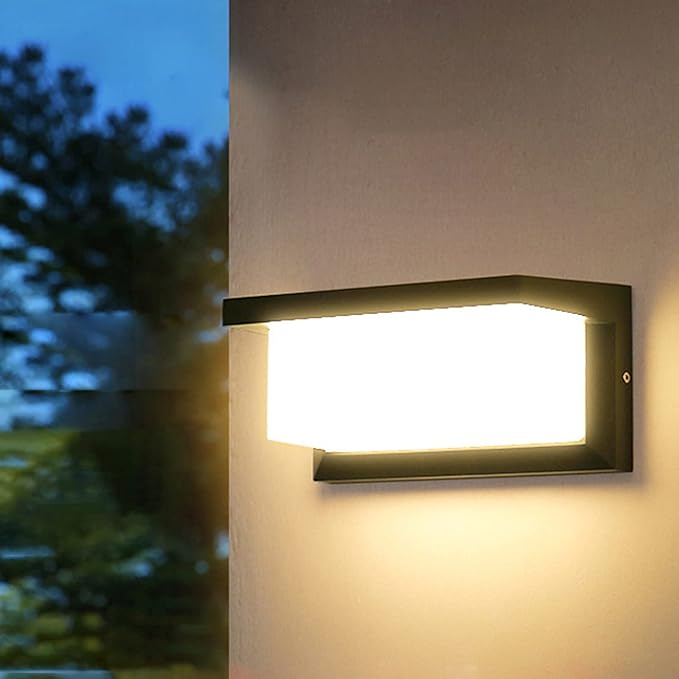 Angled outdoor light throwing a warm wash down a pale exterior wall