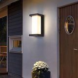 Outdoor lantern lit beside a wooden front door and window