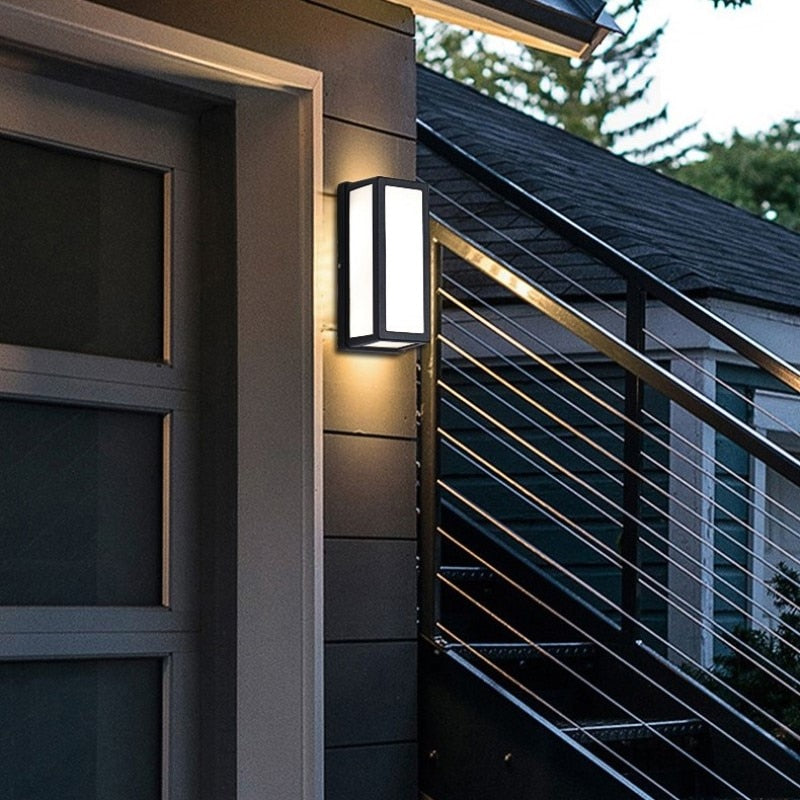 Framed outdoor light beside a glazed door and metal railing