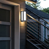 Framed outdoor light beside a glazed door and metal railing