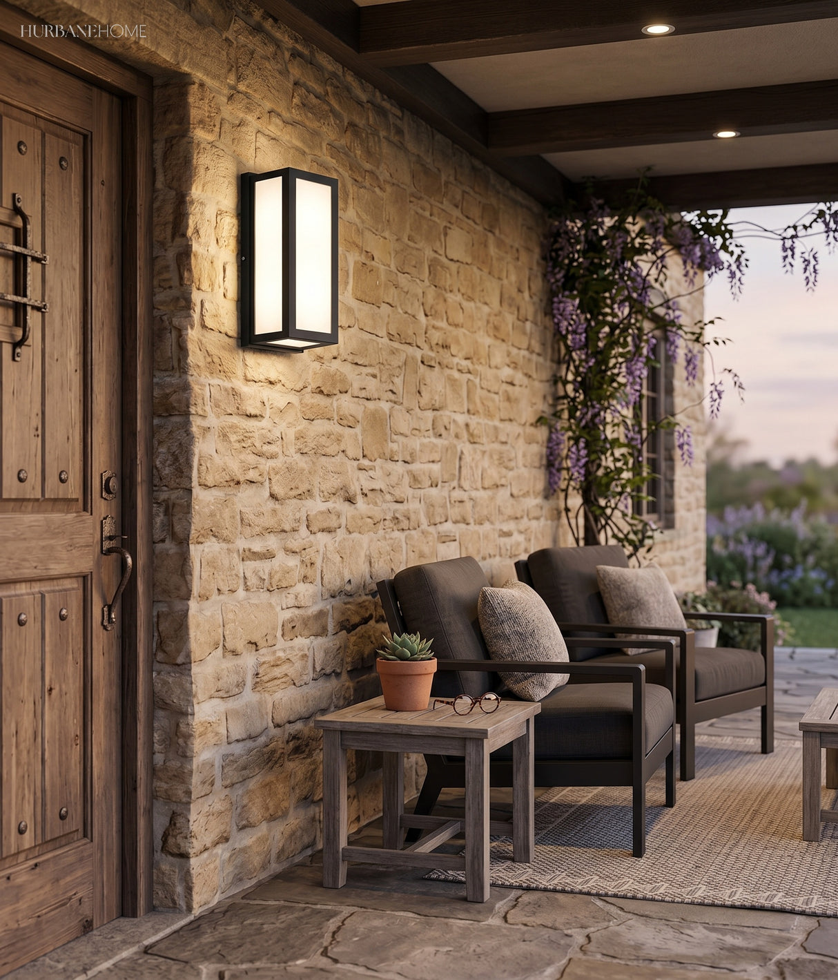 Framed outdoor lantern lit on a stone porch beside a wooden door