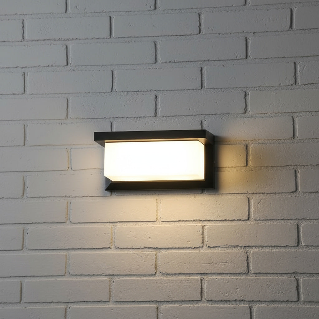 Flat slab outdoor light lit on white painted brick at night