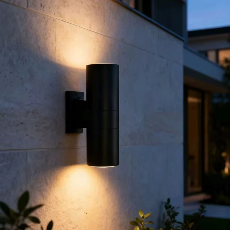 Outdoor wall light mounted near a porch for exterior lighting and entry illumination