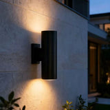 Outdoor wall light mounted near a porch for exterior lighting and entry illumination
